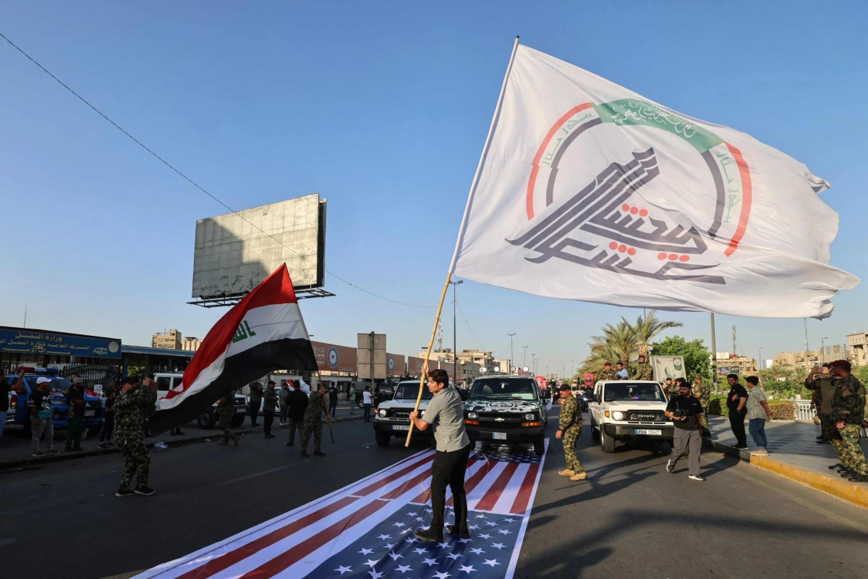 Image of Iraqi PM orders probe into PMF trampling of US flag 